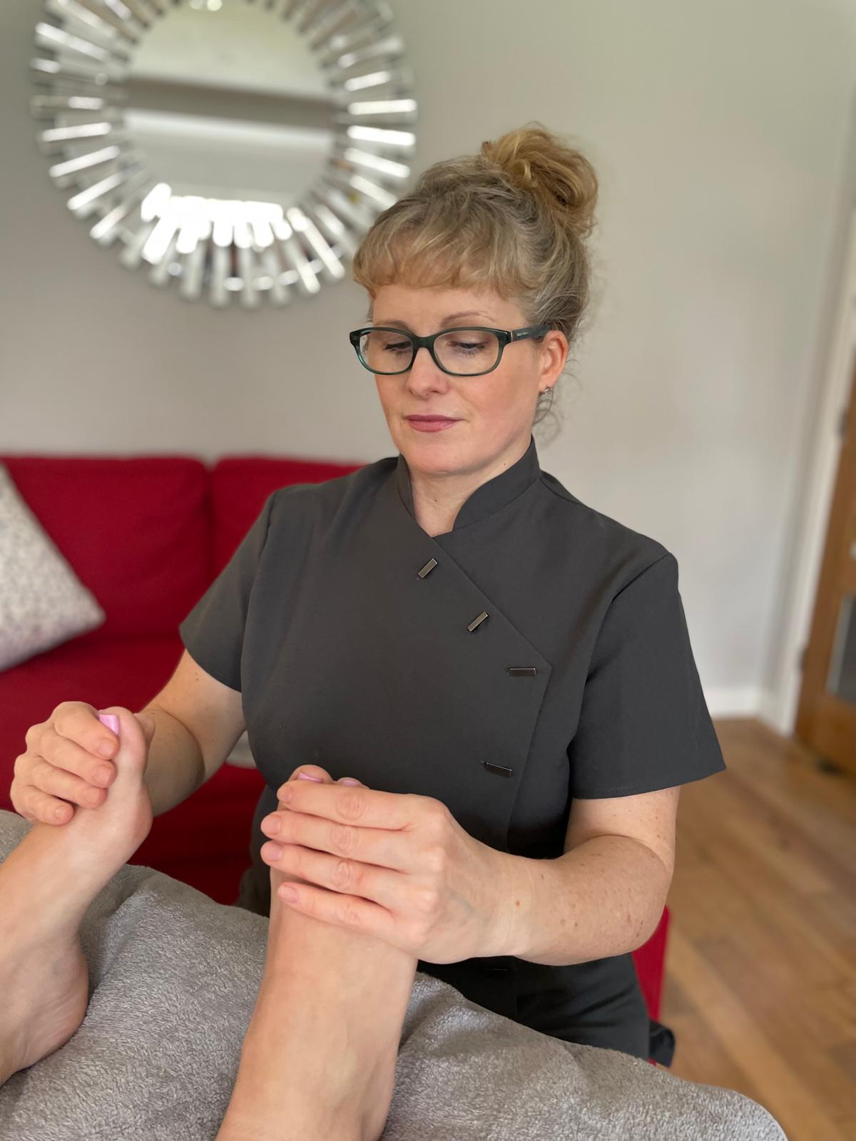 Hands on feet reflexology treatment